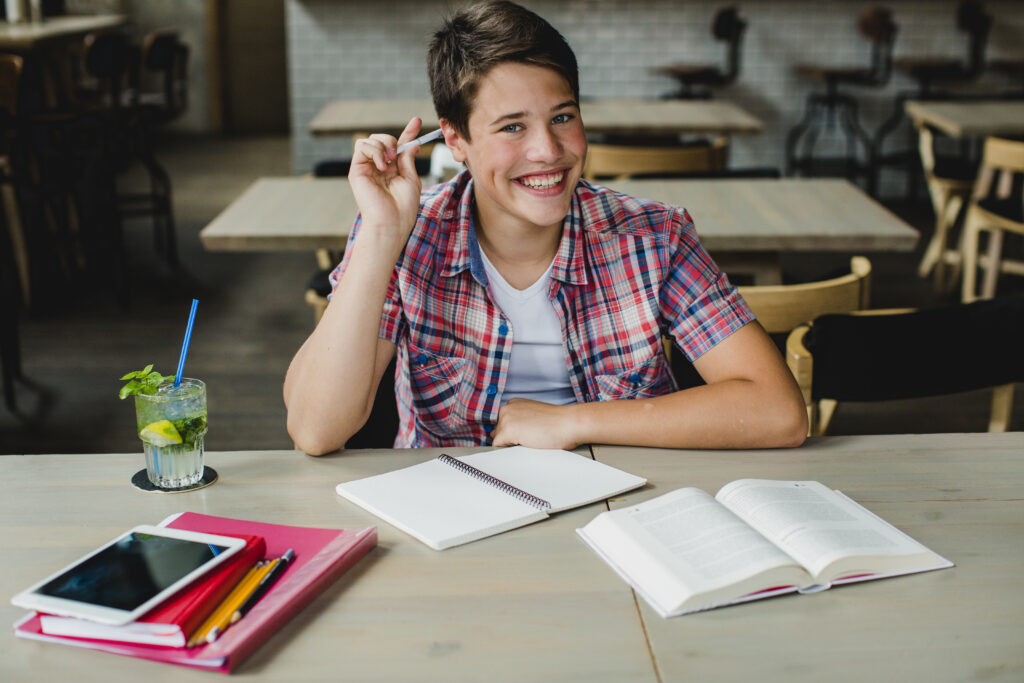 happy non binary teen studying