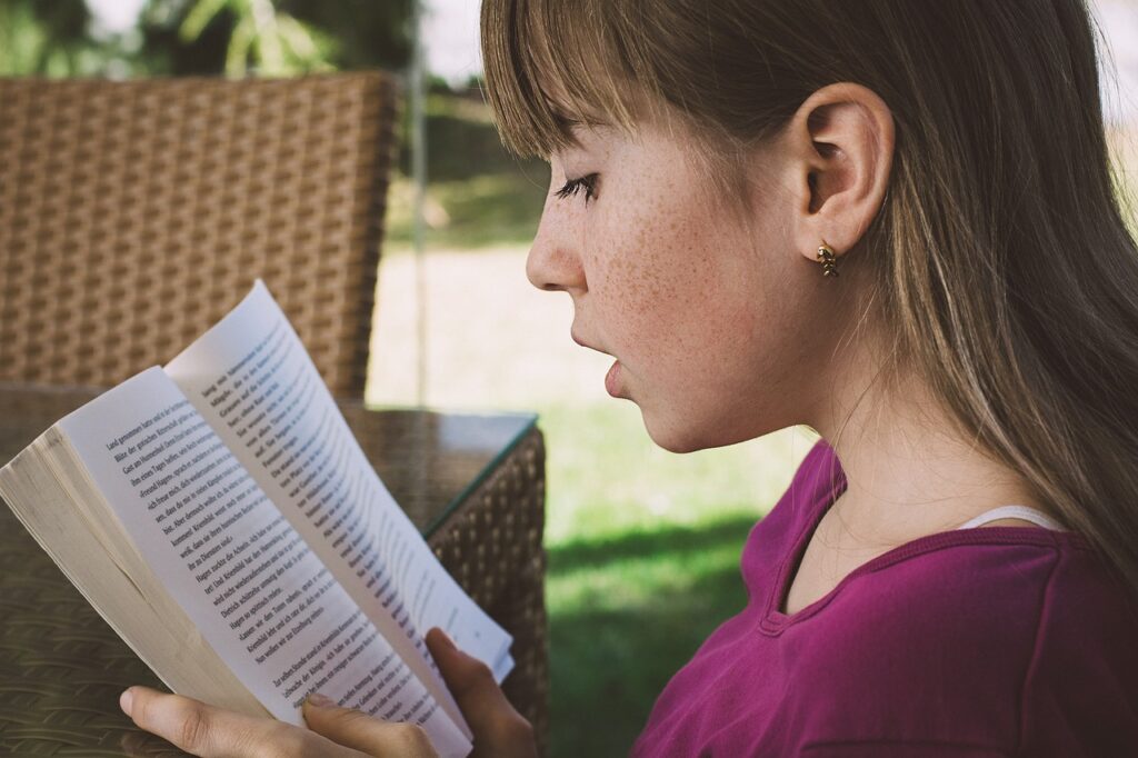 teen reading a book close up