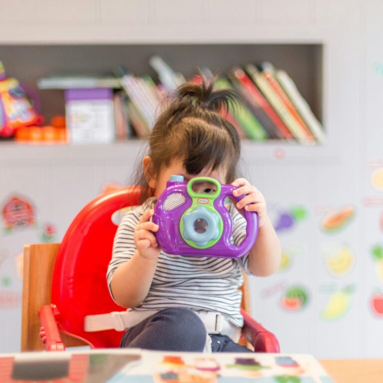 toddler with a toy camera