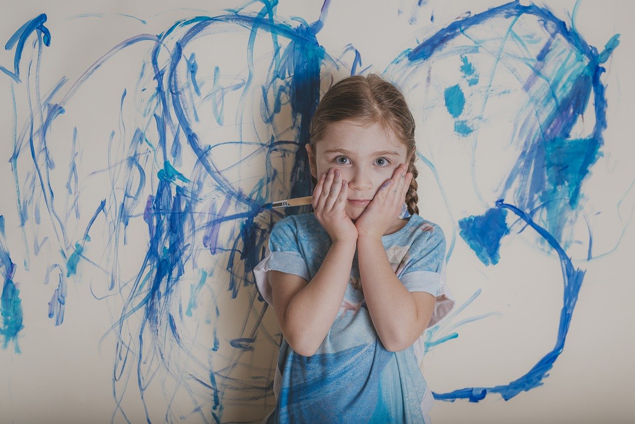 girl with paintbrush and blue painted butterfly