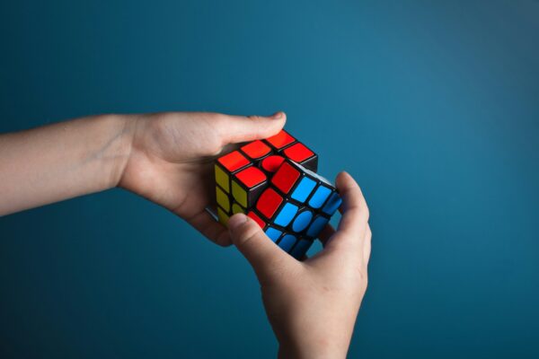 hands completing Rubics Cube